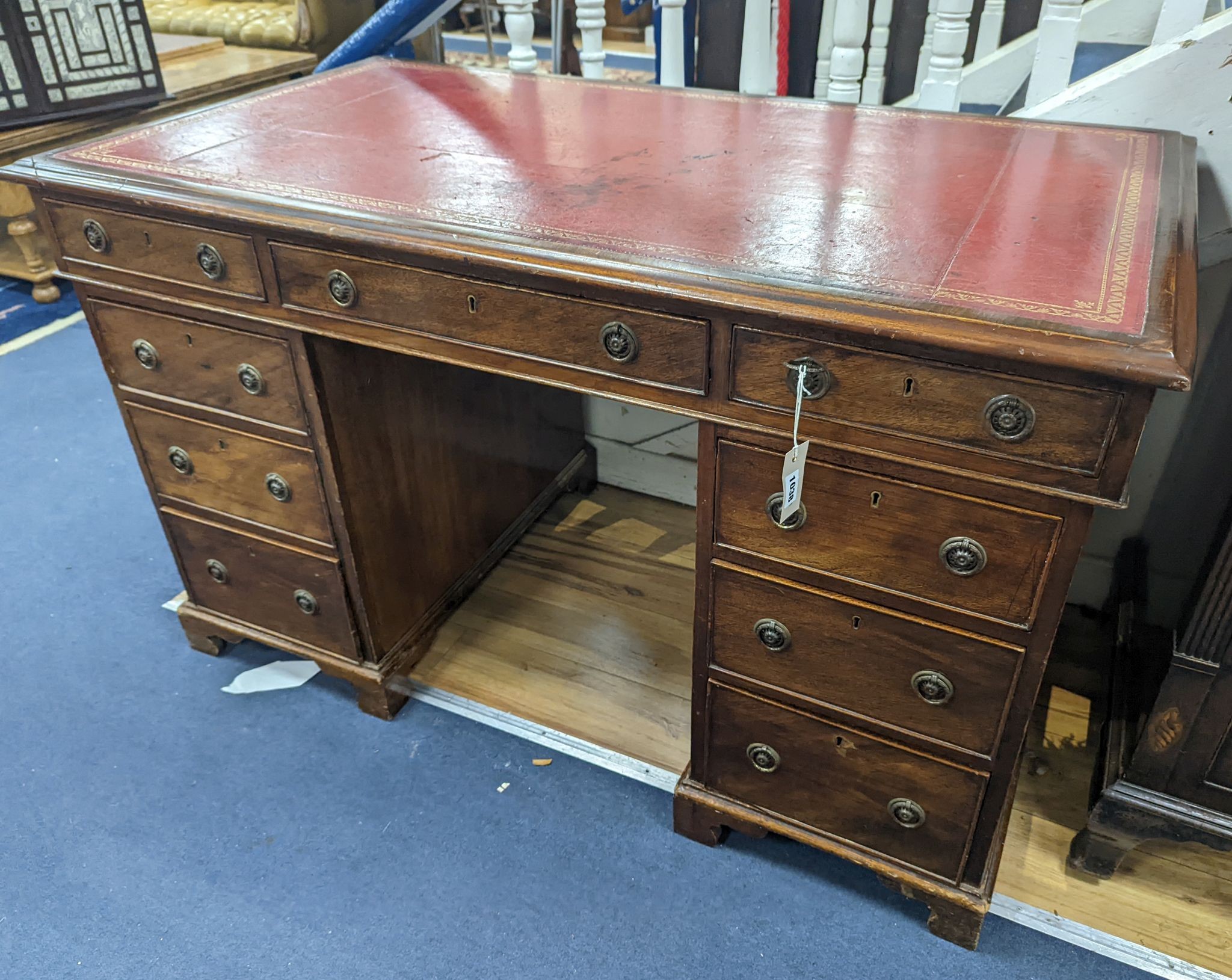 A Victorian mahogany pedestal desk with red leather inset top, length 126cm, depth 71cm, height 77cm